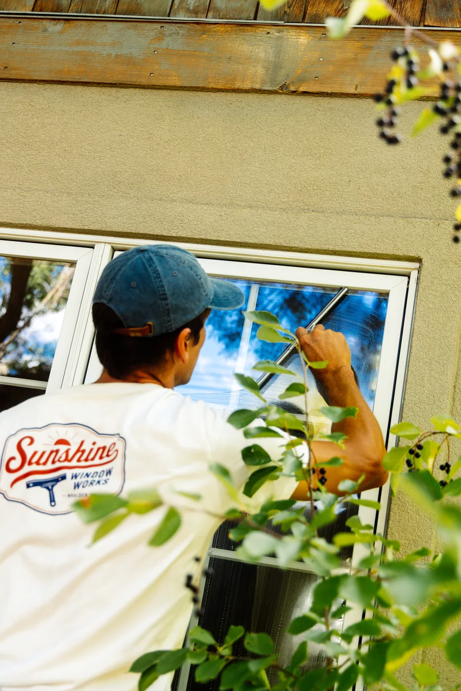 Sunshine Window Works technician cleaning a window at a Boulder-area home